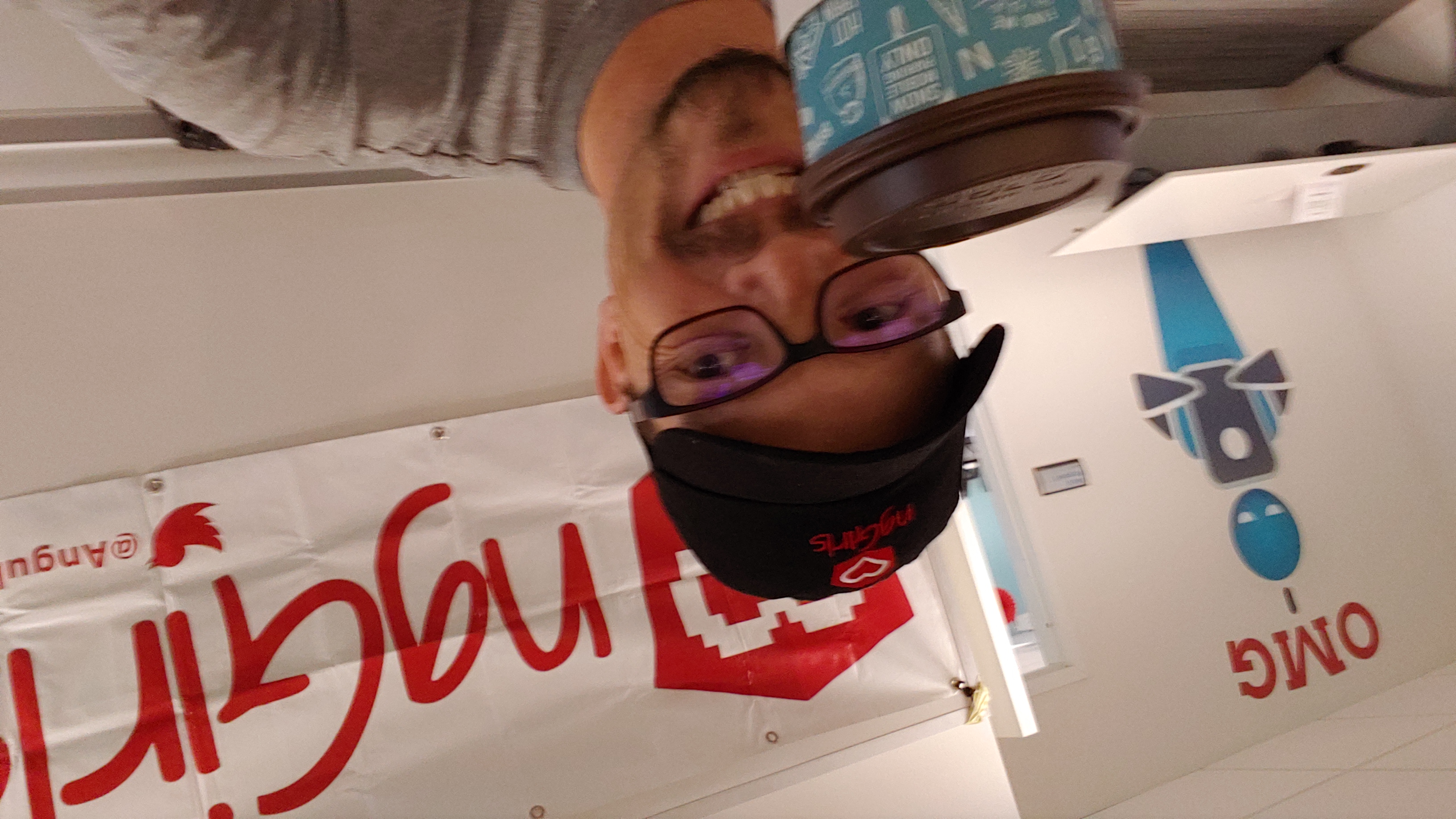 Chad holding up a coffee in front of the Ng Girls logo
